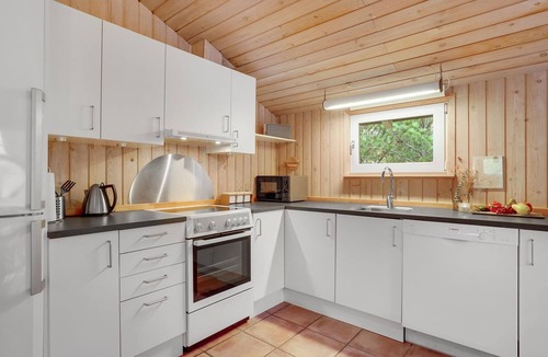 Vorupør House | On a hilly natural plot surrounded by trees, lies this beautiful wooden vacation home.