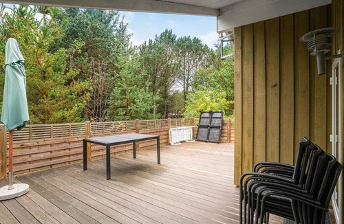 Vorupør House | On a hilly natural plot surrounded by trees, lies this beautiful wooden vacation home.