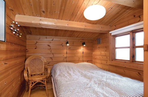 Pandrup House | On a natural plot near the water lies this renovated log house with beautiful terrace.