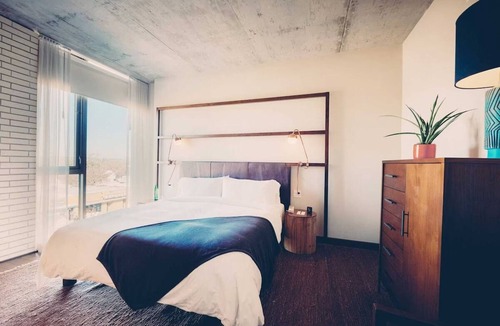 South River City Hotel | One-Bedroom Hotel Suite with Living Room & Outdoor Space
