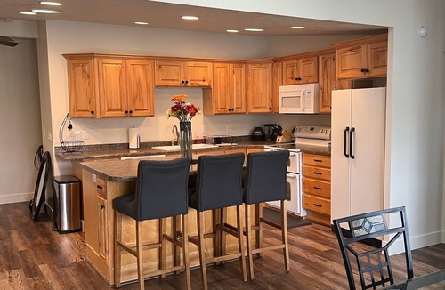 Millcreek House | Open floor plan with a covered patio and fenced yard.