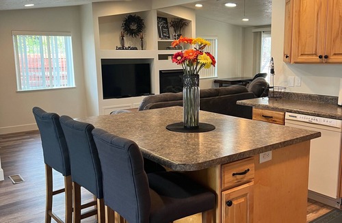 Millcreek House | Open floor plan with a covered patio and fenced yard.