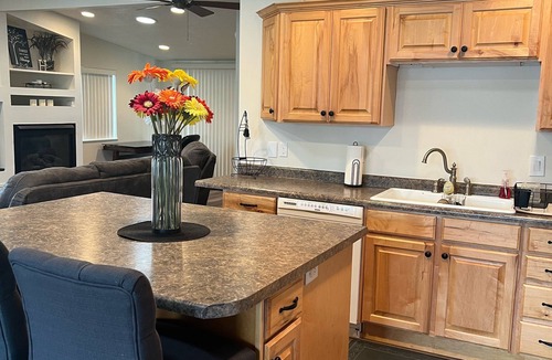 Millcreek House | Open floor plan with a covered patio and fenced yard.