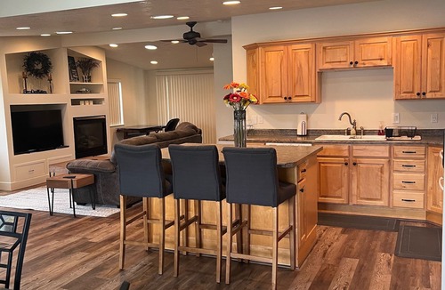 Millcreek House | Open floor plan with a covered patio and fenced yard.