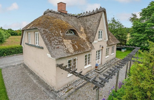 Krusaa House | Outside Krusau welcomes you this beautiful thatched house.