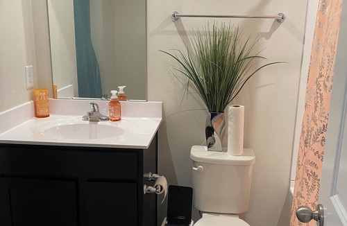 Milford House | Primary bedroom and private bathroom space. Shared kitchen and dining area