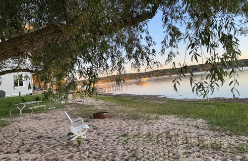 Onekama Apartment | Private beachfront 2BR w deck and firepit in Onekama