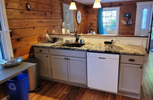 Town Bank House | Private forested log cabin steps from the Bay - pet friendly