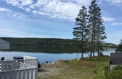 Liscomb Cottage | Private self contained cottage with terraced decking right to the water.