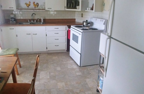 Emporia Apartment | Private Upper Deck surrounded by flower and vegetable gardens. Pet friendly