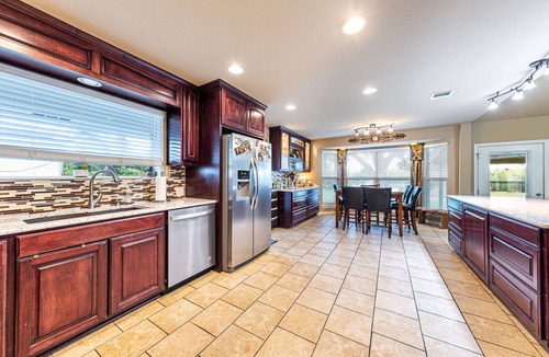 Pflugerville House | Ranch Home w Gorgeous Kitchen-Office-Big Screens-Covered Porch-Playscape & Lg Basketball Court