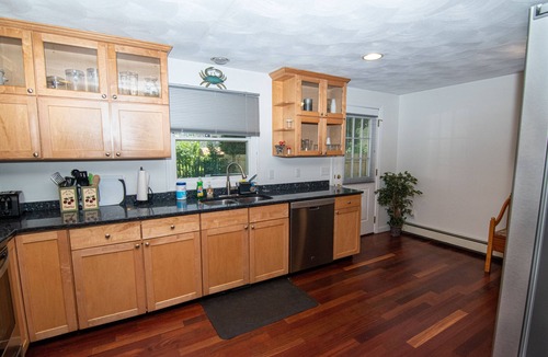 Saunderstown House | Relax on front rockers or private back yard/covered deck. Easy access Route 1A.