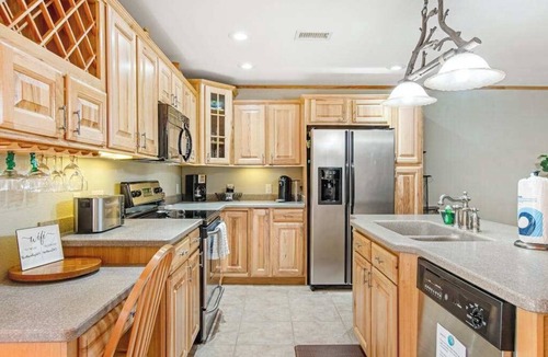 Arkdale Condo | Riverfront golf resort condo with pool, hot tub, volleyball, & fairway-view deck