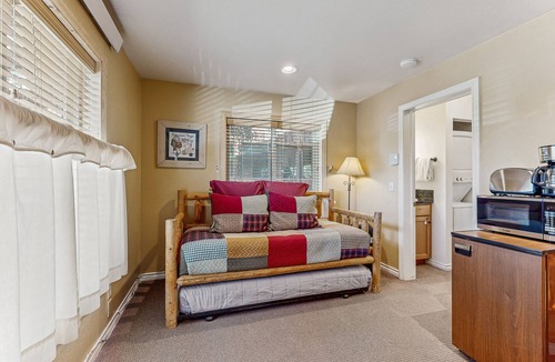 Grand Lake Condo | Riverfront retreat with a kitchenette, washer/dryer, & shared patio