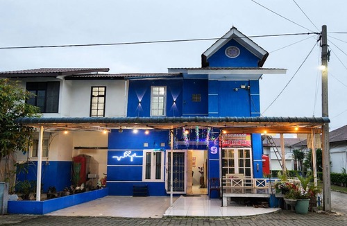 Berastagi Villa | Rumah dua lantai berwarna biru cerah tampak bercahaya di malam hari