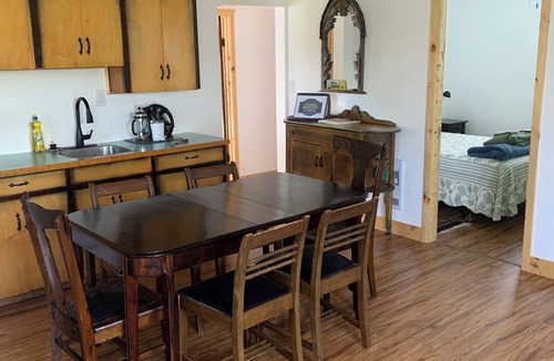 Erickson Cottage | Rustic cabin near RMNP with screened-in deck, meadow view, and wood stove