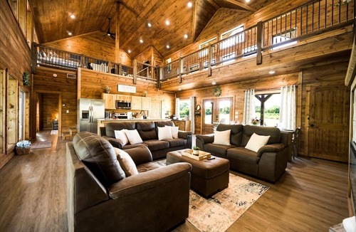 Golden Cabin | Rustic cabin on a quiet stretch of the Glover River. Three queen suites and a bunk loft sleep up to 13. Kayak from the backyard, soak in the hot tub, gather at the fire pit. Inside: game loft with ping pong, and Nintendo. FREE Gym at Sweat Shack.