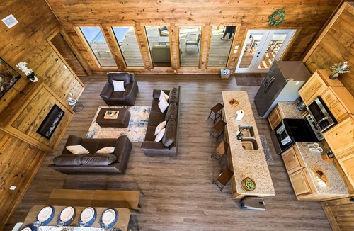 Golden Cabin | Rustic cabin on a quiet stretch of the Glover River. Three queen suites and a bunk loft sleep up to 13. Kayak from the backyard, soak in the hot tub, gather at the fire pit. Inside: game loft with ping pong, and Nintendo. FREE Gym at Sweat Shack.