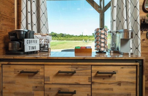 Golden Cabin | Rustic cabin on a quiet stretch of the Glover River. Three queen suites and a bunk loft sleep up to 13. Kayak from the backyard, soak in the hot tub, gather at the fire pit. Inside: game loft with ping pong, and Nintendo. FREE Gym at Sweat Shack.