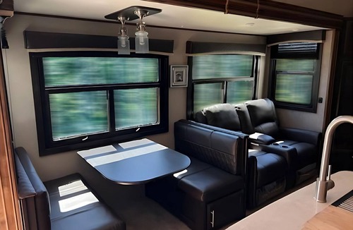 Kenora Resort | RV 5 Rustic Charm w/Queen Bed with Forest Background