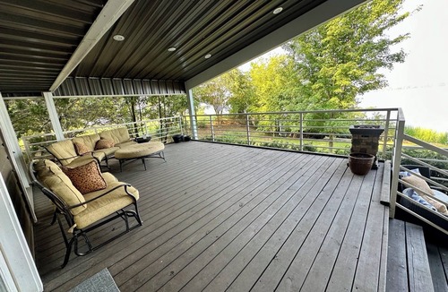 Lafayette County House | Secluded getaway with lakefront views. Spacious covered deck and dock access.