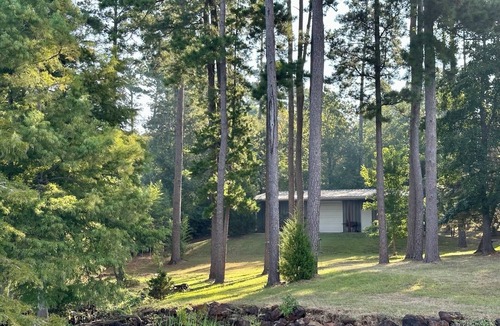 Lafayette County House | Secluded getaway with lakefront views. Spacious covered deck and dock access.