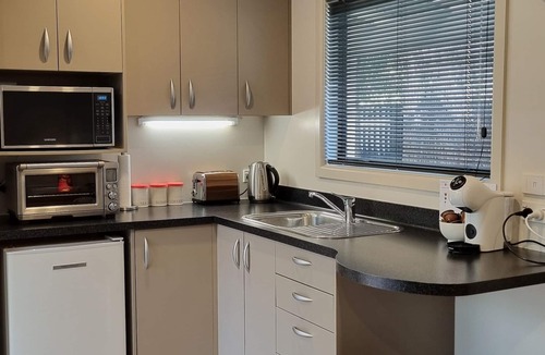 Clive Cottage | Secluded Riverside Cottage set in native garden.