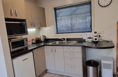 Clive Cottage | Secluded Riverside Cottage set in native garden.