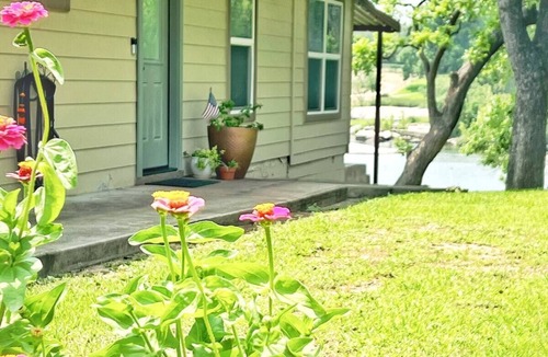 Buchanan Dam House | Shaded riverfront getaway. Dog friendly