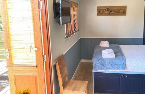 Hawes Cottage | Shepherd’s Hut with an open plan design with king-size bed.