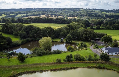Hadlow Down Cabin | Snug & Secluded shepherds hut with balcony over lake.