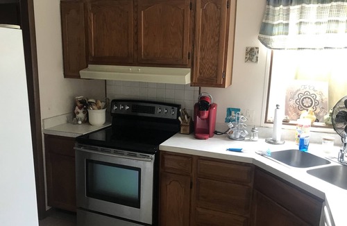 Tow House | Spacious open floor plan with beautiful oak trees.