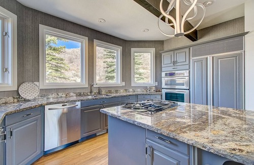 Deer Valley House | Spacious patio at secluded home in peaceful Deer Valley with private hot tub, BBQ grill