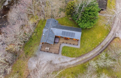 Whitebridge Ski Chalet | Spacious riverside lodge with mountain views.