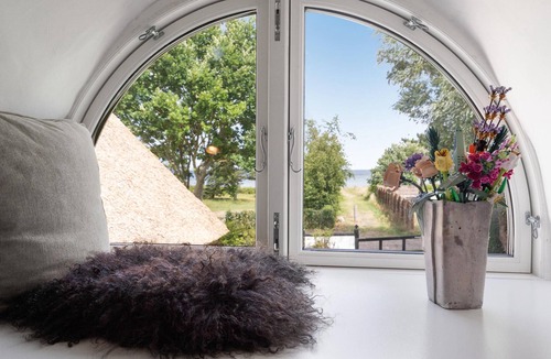 Vejlby Fed House | Spend a wonderful vacation in this comfortable cottage overlooking the sea from the property.