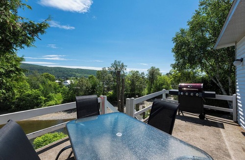 Baie-St-Paul House | Stilt area overlooking a river