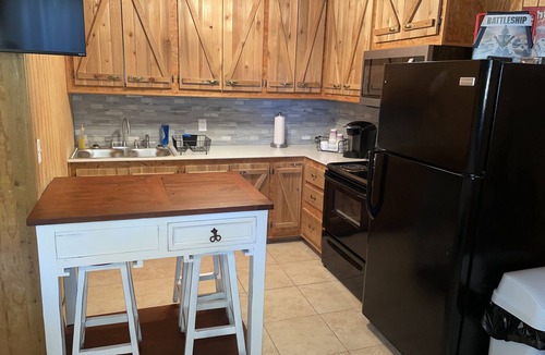 Porum Cabin | Studio cabin #3 with lake view and boat dock access, outdoor seating.