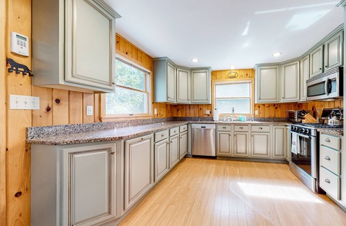 Pine River Pond House | Stunning lakefront home with private dock, deck, firepit, and lake view