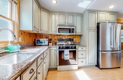 Pine River Pond House | Stunning lakefront home with private dock, deck, firepit, and lake view