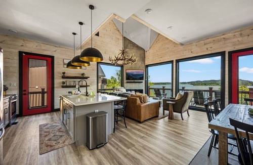 Sevierville Cabin | Stunning Mtn Lodge on Lake with two Story Dock, Indoor Pool, Arcade,and Hot Tub.