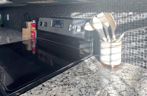 San Angelo House | Stylish corner home with cozy interiors, a private bar, and inviting charm