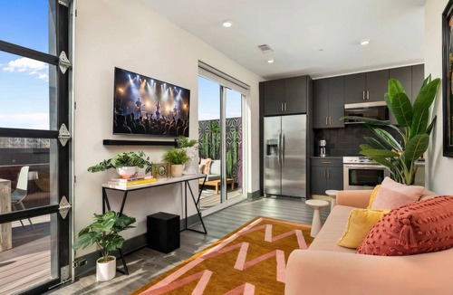 Rolling Mill Hill Apartment | Summer rooftop deck, skyline views, indoor-outdoor living near Broadway