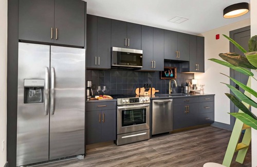 Rolling Mill Hill Apartment | Summer rooftop deck, skyline views, indoor-outdoor living near Broadway