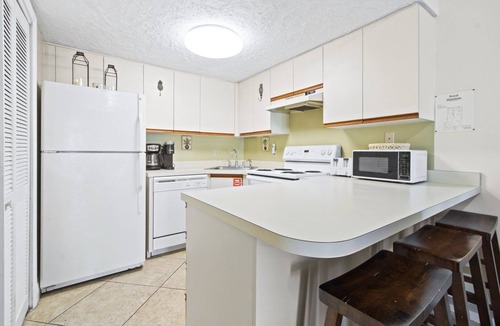 Cape Caneveral Beach Gardens Condo | Sunlit Ground‑Floor Corner Condo ☀️ Private Patio, Steps to Beach & Pool!