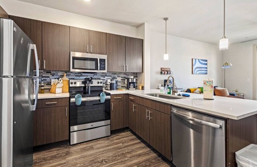 Vickery Meadow Apartment | Sunlit Midtown Suite Pool & Gym Bliss
