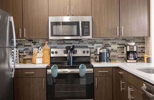 Vickery Meadow Apartment | Sunlit Midtown Suite Pool & Gym Bliss
