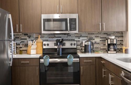 Vickery Meadow Apartment | Sunlit Midtown Suite Pool, Gym Bliss