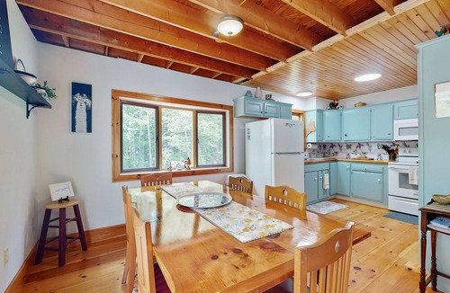 Warren House | Sunny, lakefront home on South Pond with private dock, great deck & firepit