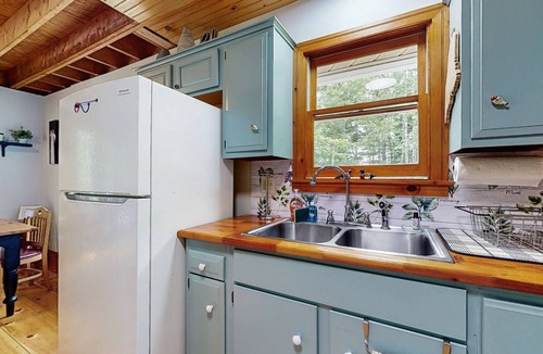 Warren House | Sunny, lakefront home on South Pond with private dock, great deck & firepit