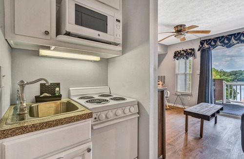North Shore Condo | Sunset Landing - Waterfront condo with lake-view deck, tennis court & pool